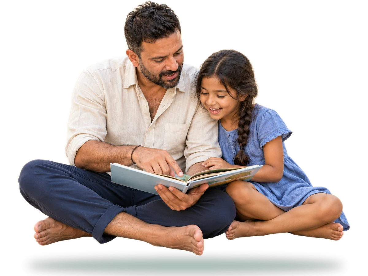 A father sitting cross-legged on the ground reading a picture book with his young daughter, who smiles as she follows the page
